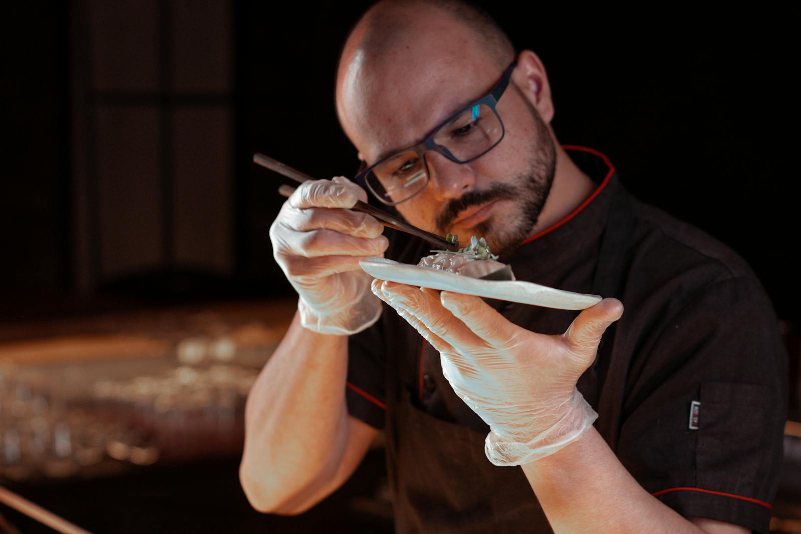 Chef and team developing a new restaurant menu — recipes, costing notes, and ingredient samples on the pass
